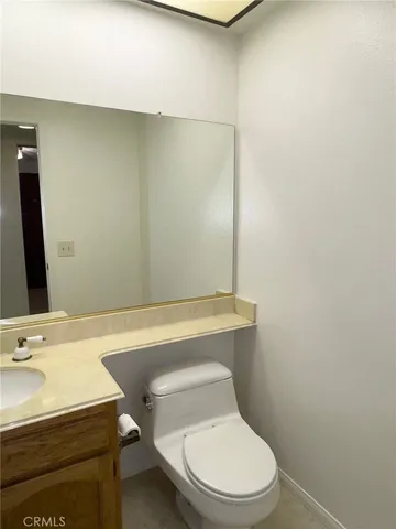 a white toilet sitting next to a bathroom sink