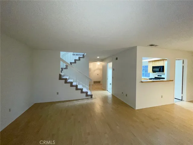 an empty room with a empty space and windows