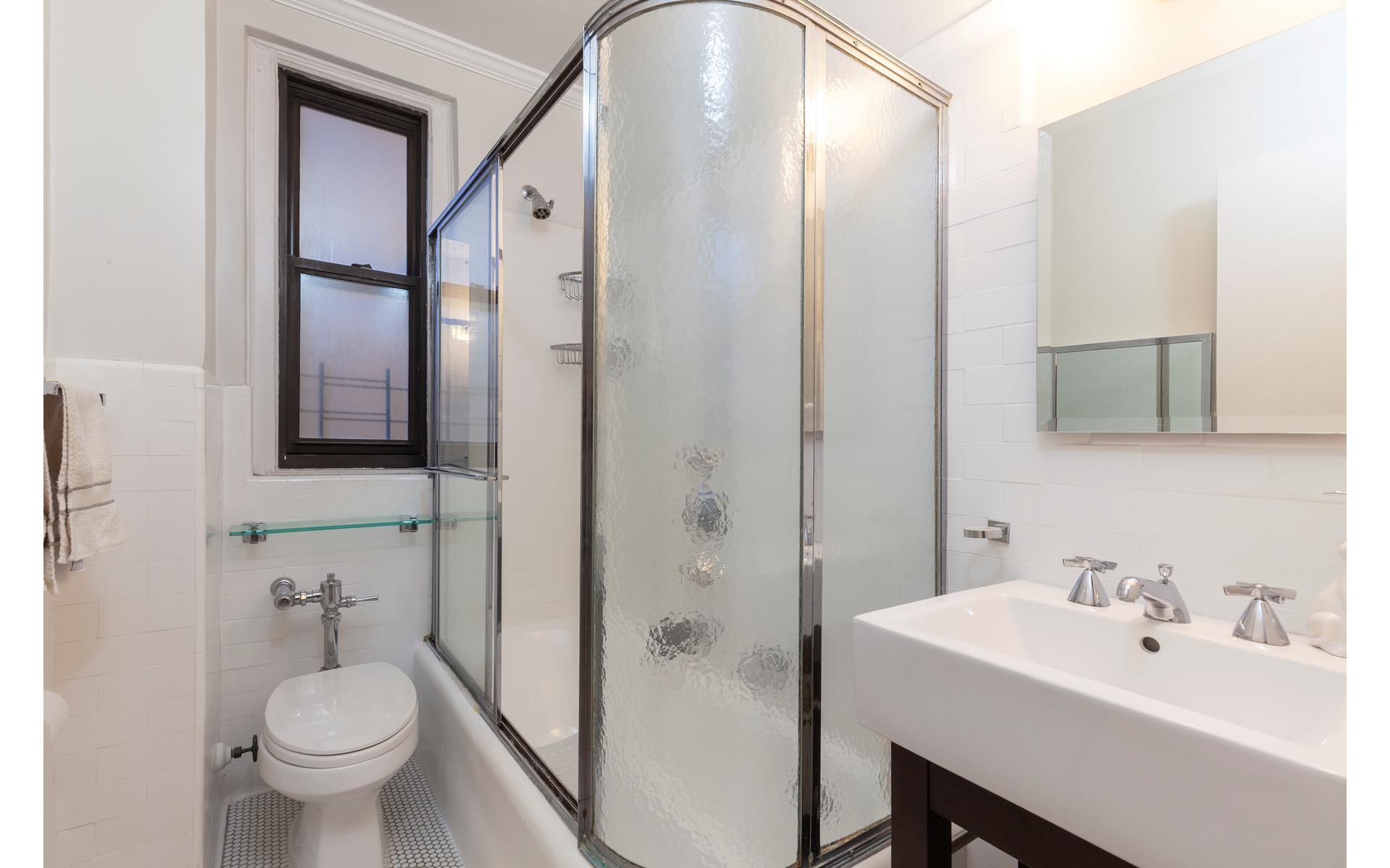 179 East 79th Street, Unit 4CD Manhattan, NY 10075 - Photo 10 of 14 a bathroom with a toilet a sink and mirror