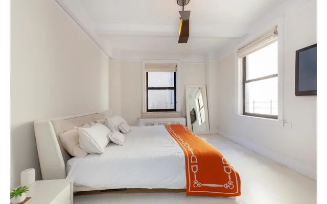 a bedroom with a bed and window