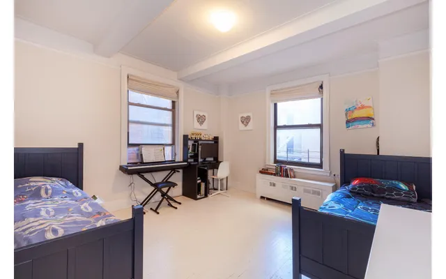 a bedroom with furniture and a window