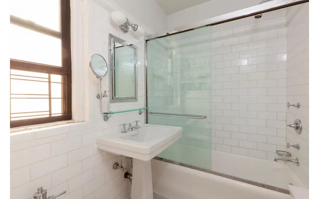 a bathroom with a sink a mirror and a bathtub