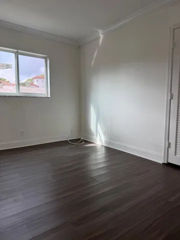 a view of wooden floor and windows in a room