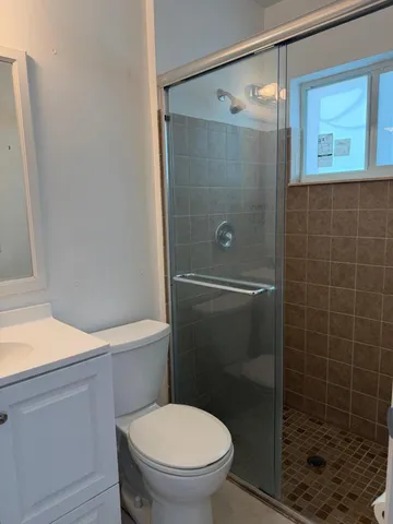 a bathroom with a toilet and a shower