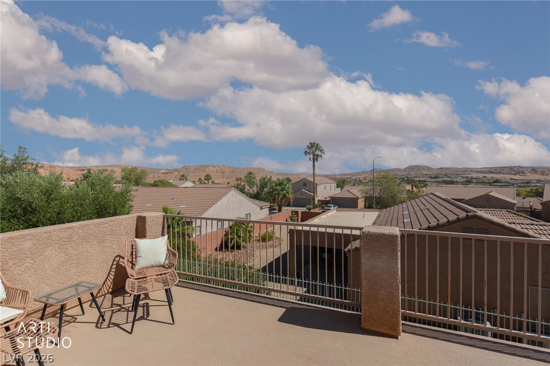 387 Silver Road Mesquite, NV 89027 - Photo 34 of 46 An open balcony overlooks a desert neighborhood with mountain backdrops and wide skies.