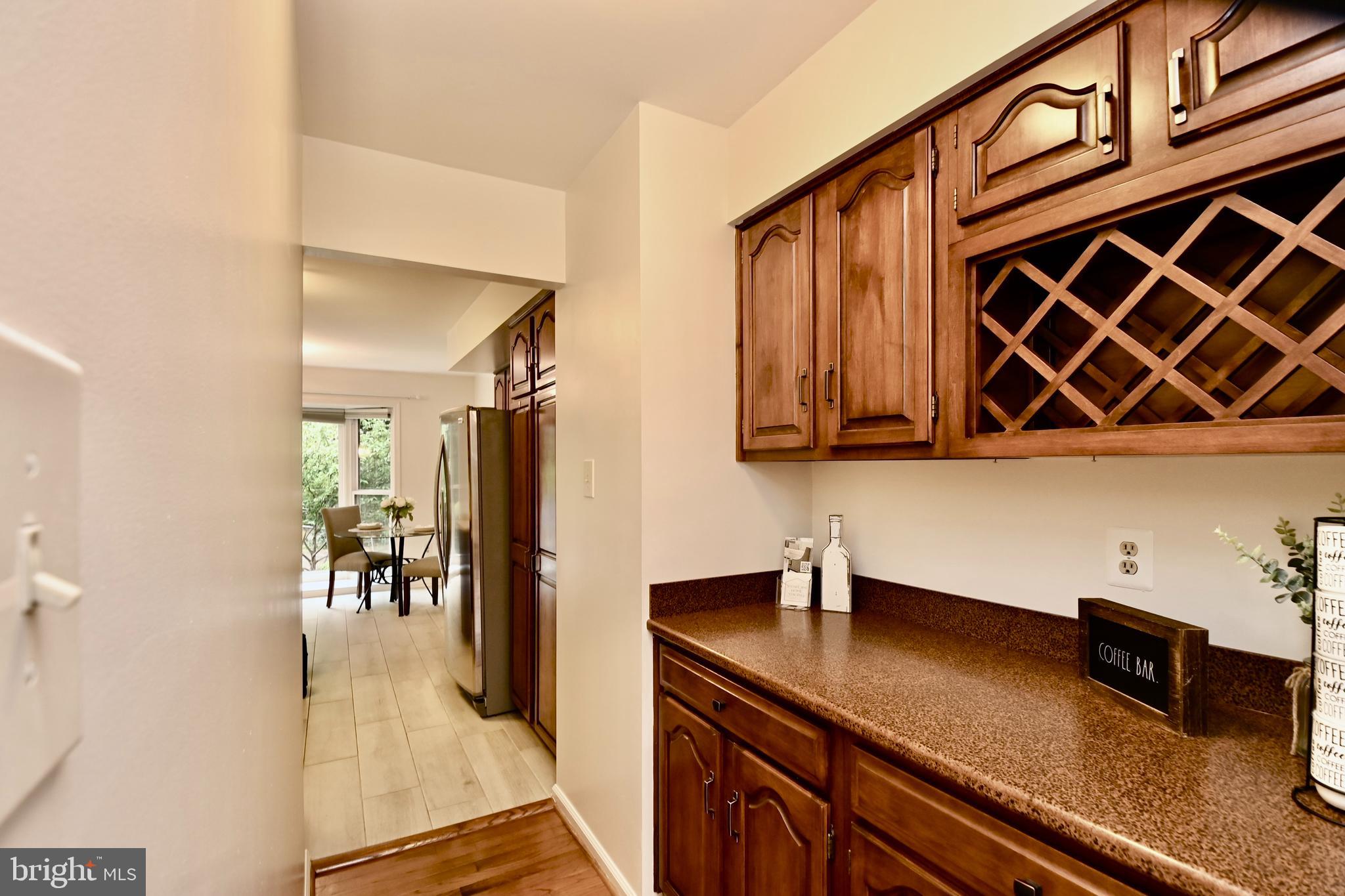 7443 Crestberry Lane Bethesda, MD 20817 - Photo 11 of 46 a kitchen with stainless steel appliances granite countertop a sink and cabinets