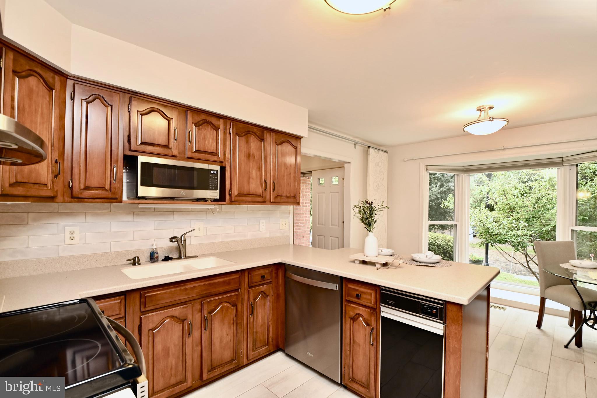 7443 Crestberry Lane Bethesda, MD 20817 - Photo 16 of 46 a kitchen with a sink cabinets and window