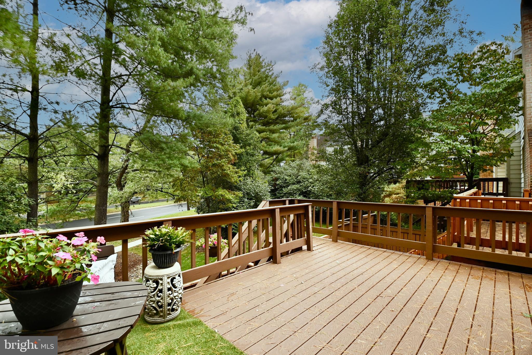 7443 Crestberry Lane Bethesda, MD 20817 - Photo 18 of 46 a view of a deck with two chair and wooden floor