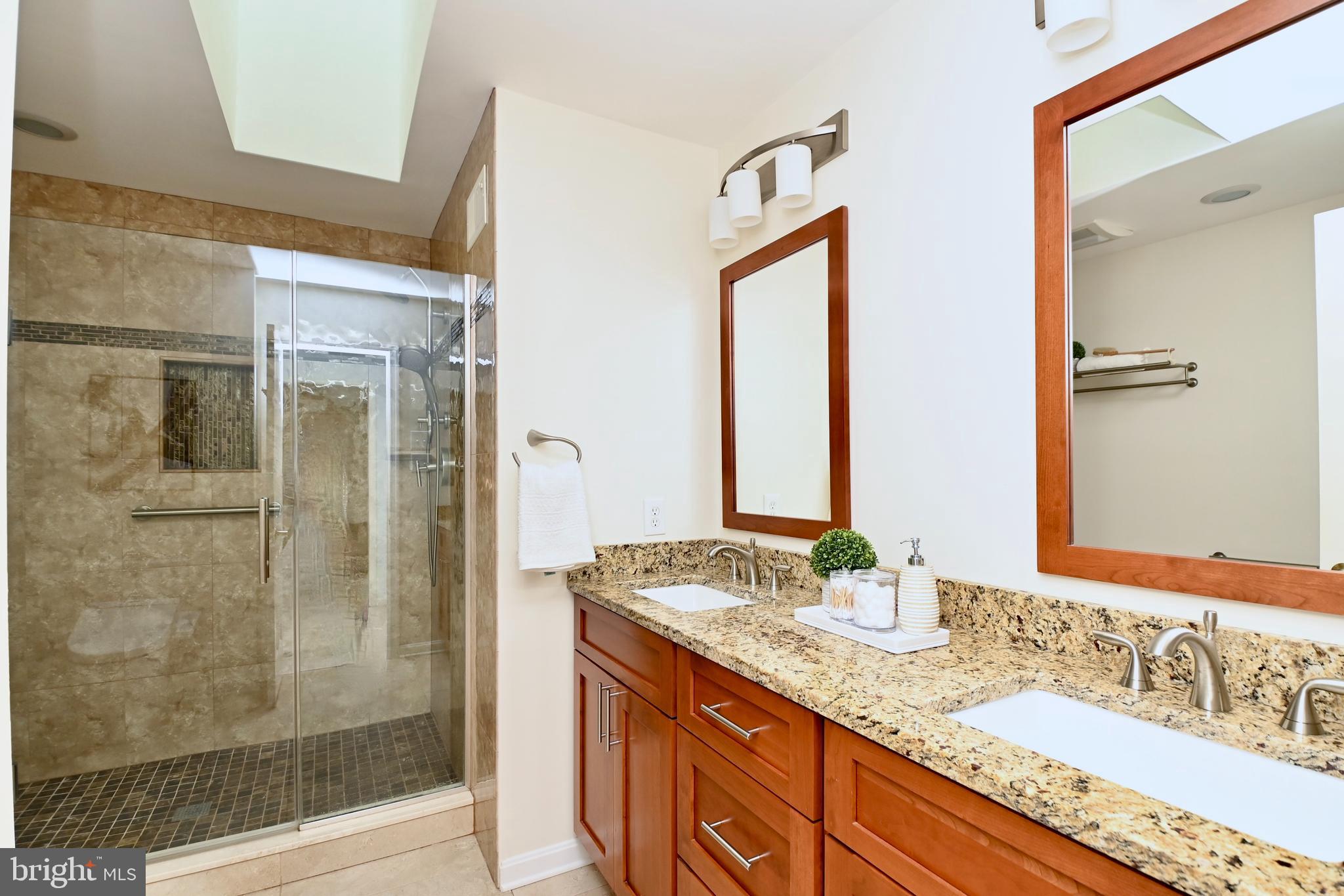 7443 Crestberry Lane Bethesda, MD 20817 - Photo 25 of 46 a bathroom with a granite countertop sink and a mirror