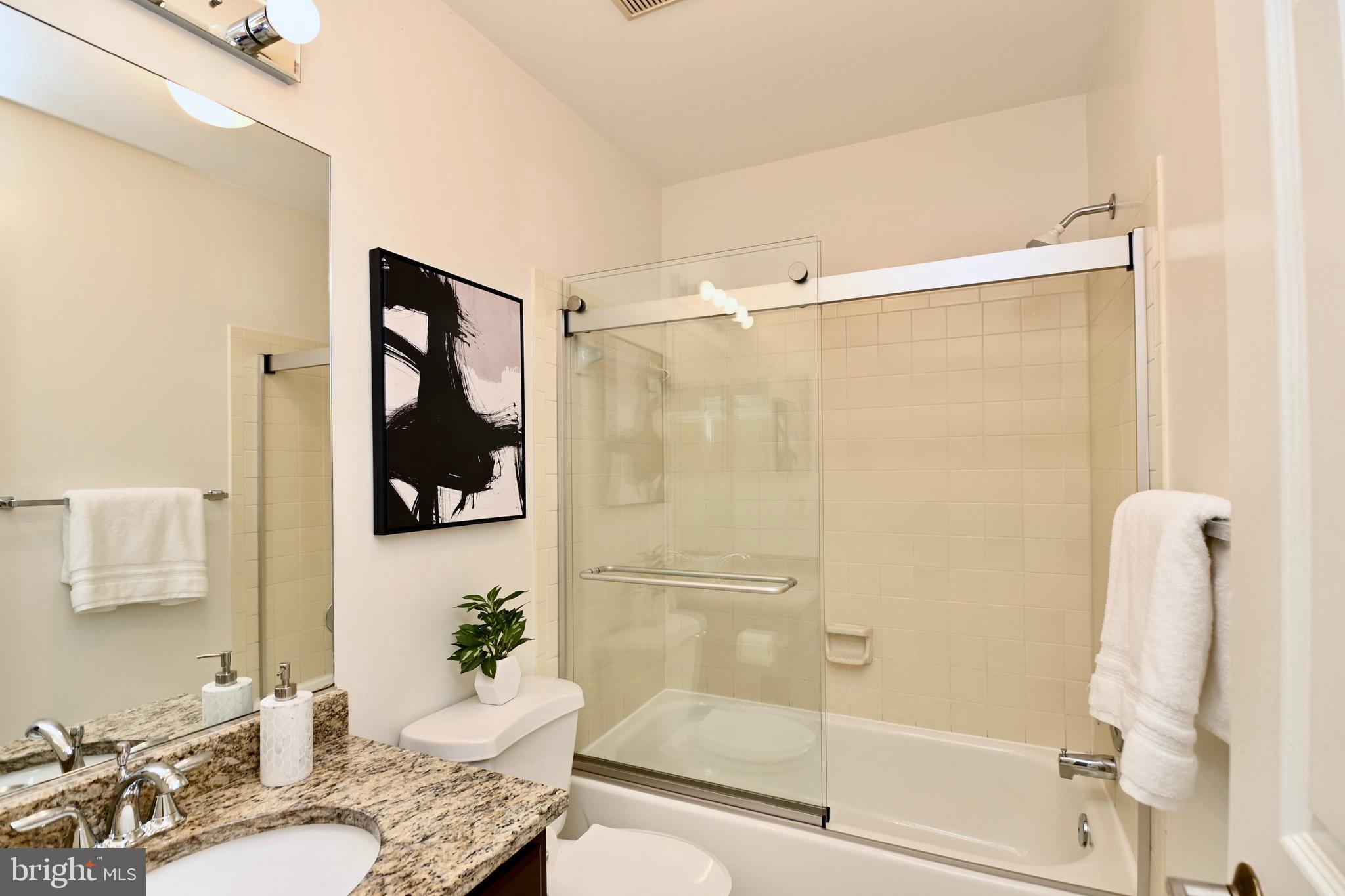 7443 Crestberry Lane Bethesda, MD 20817 - Photo 29 of 46 a bathroom with a granite countertop shower mirror and a sink