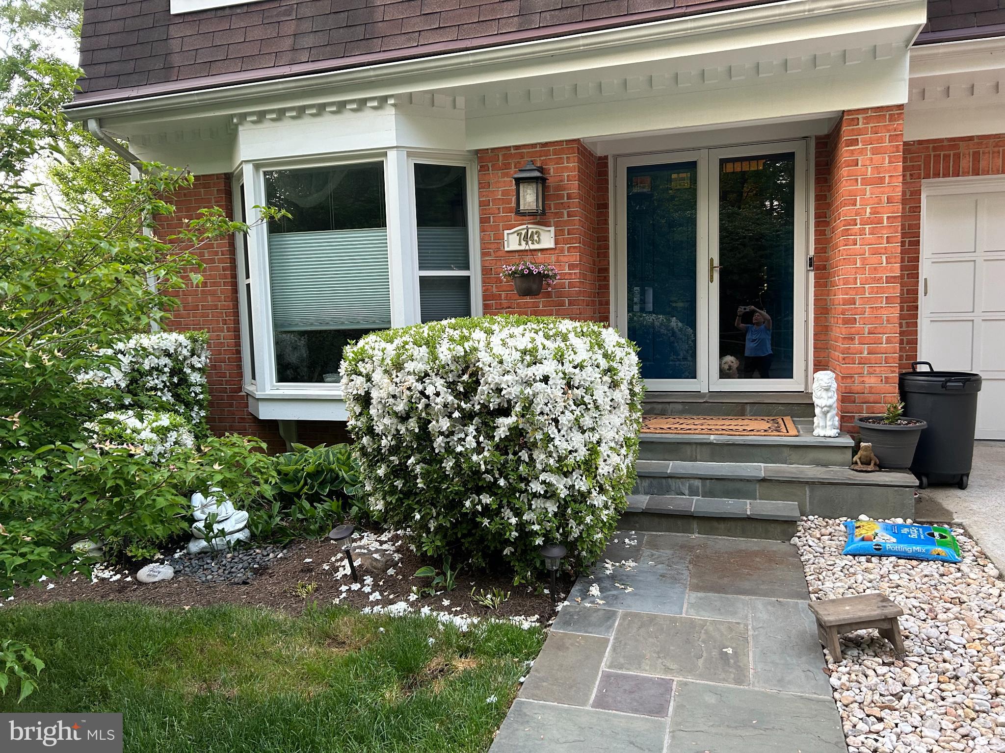 7443 Crestberry Lane Bethesda, MD 20817 - Photo 3 of 46 a front view of a house with garden