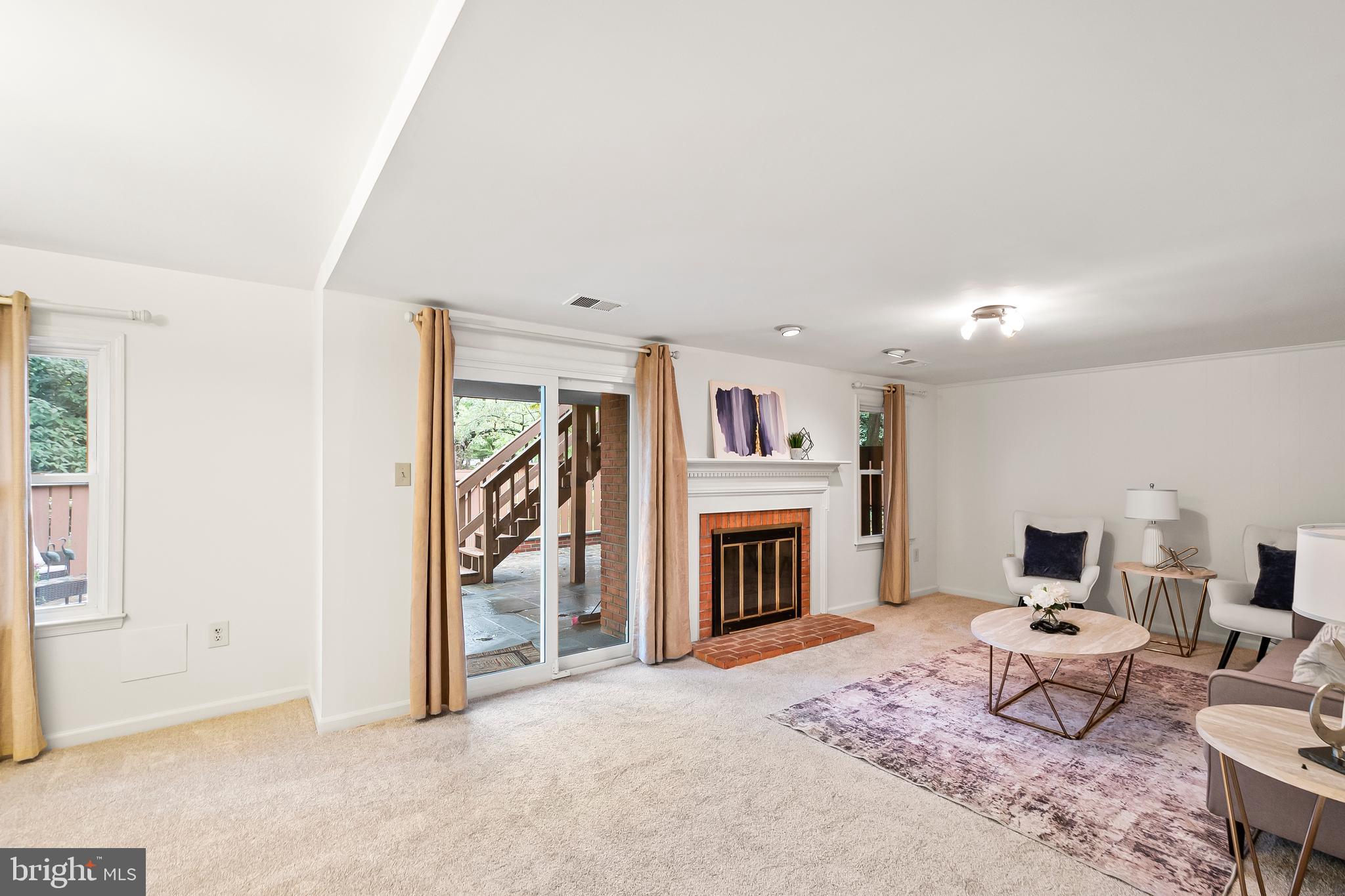 7443 Crestberry Lane Bethesda, MD 20817 - Photo 32 of 46 a living room with furniture a fireplace and a flat screen tv