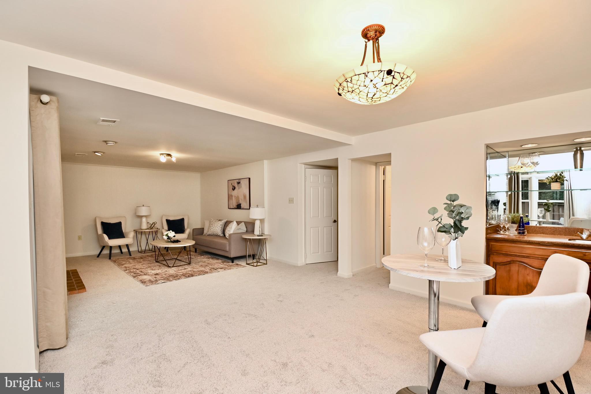 7443 Crestberry Lane Bethesda, MD 20817 - Photo 35 of 46 a living room with furniture and a chandelier