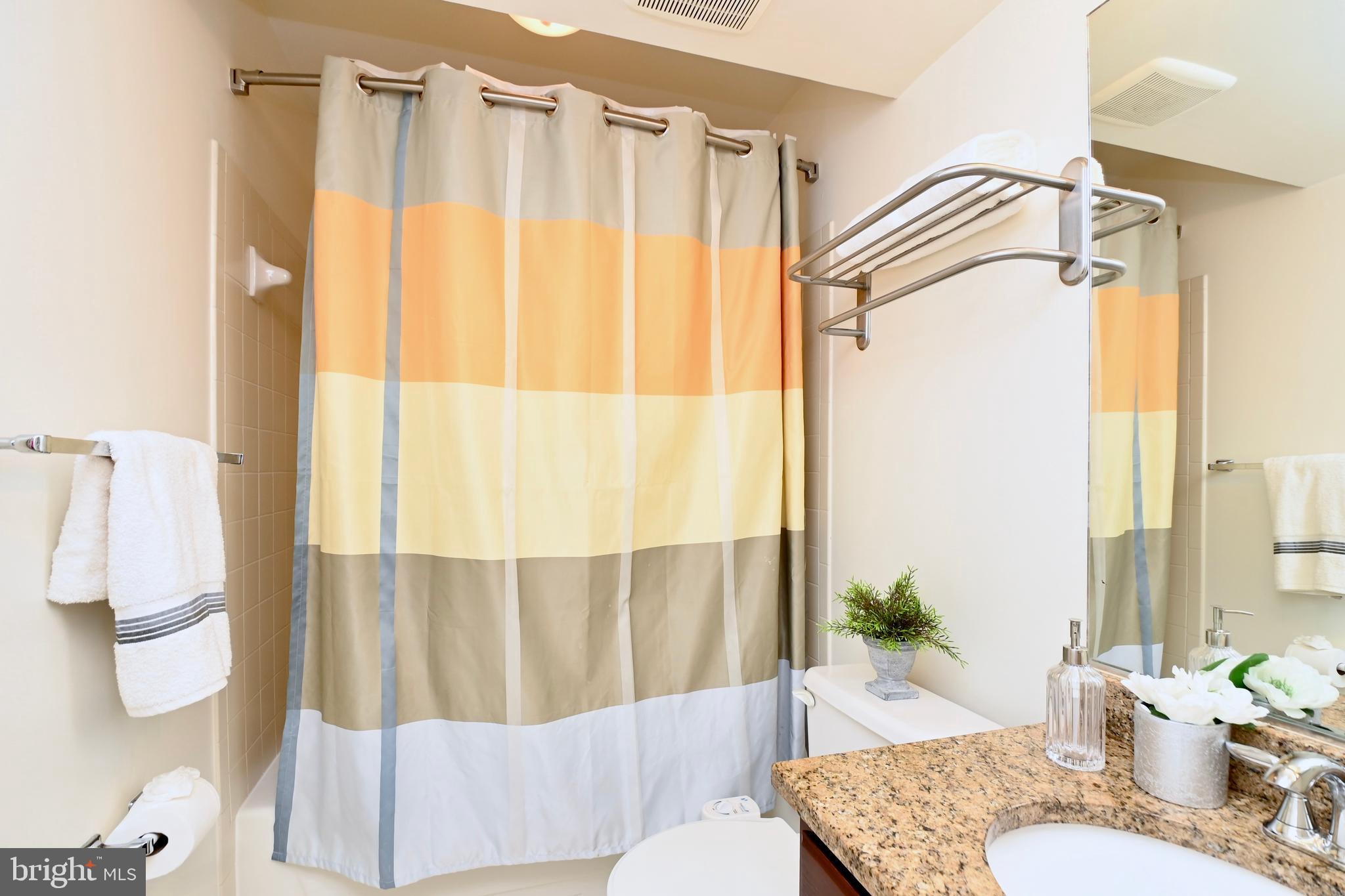 7443 Crestberry Lane Bethesda, MD 20817 - Photo 37 of 46 a bathroom with a granite countertop sink and a mirror