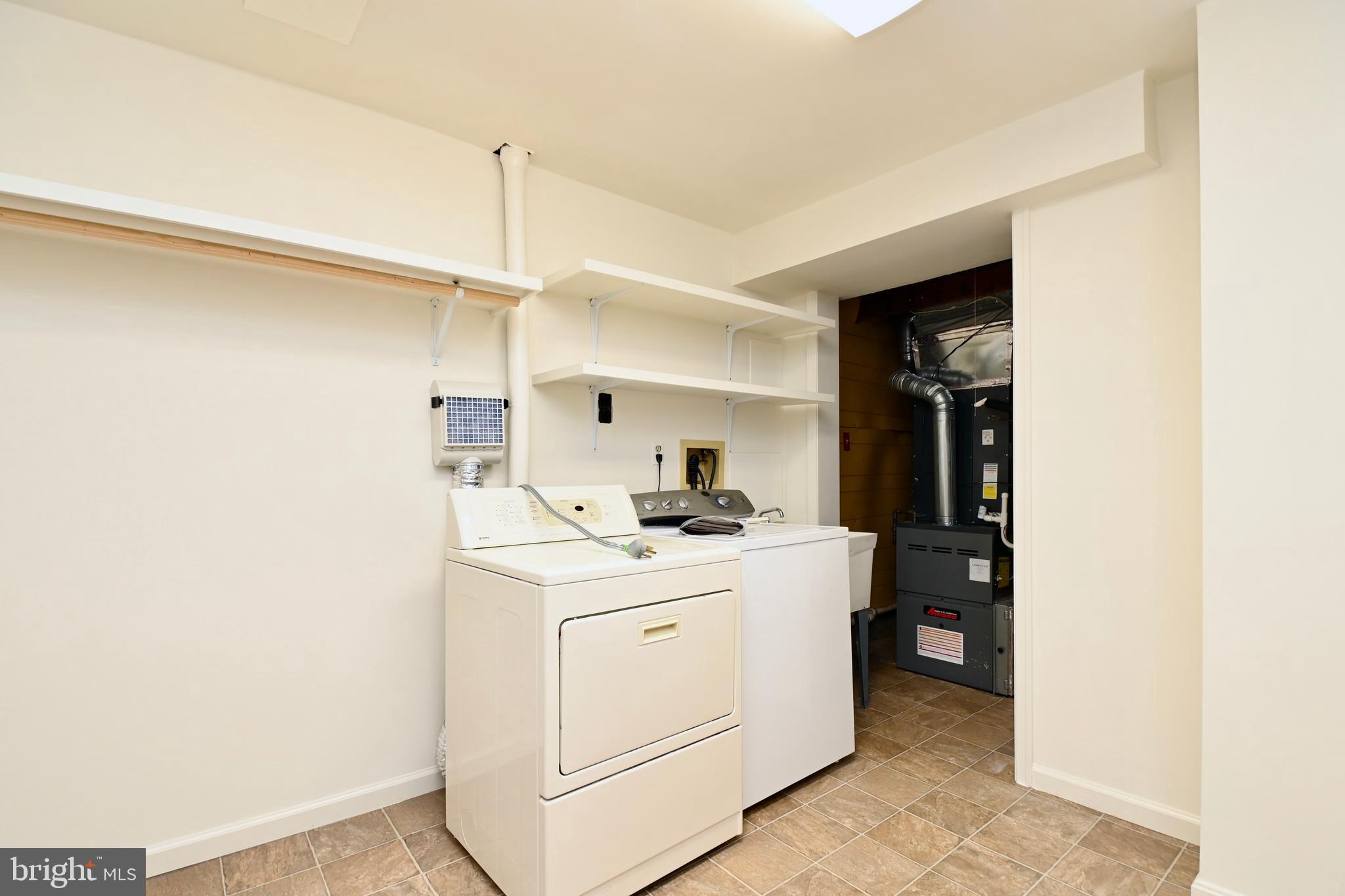7443 Crestberry Lane Bethesda, MD 20817 - Photo 38 of 46 a utility room with cabinets washer and dryer
