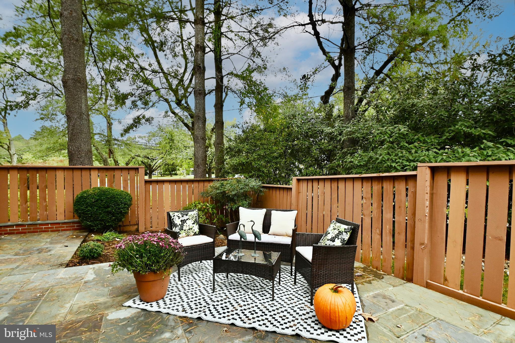 7443 Crestberry Lane Bethesda, MD 20817 - Photo 39 of 46 a patio with water table and chairs