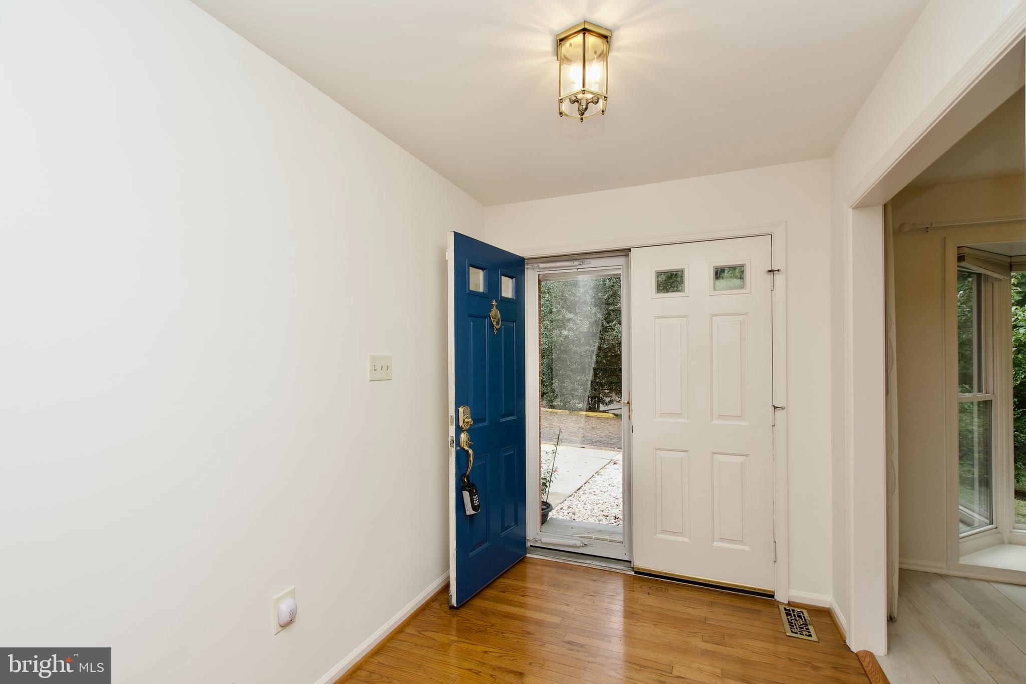 7443 Crestberry Lane Bethesda, MD 20817 - Photo 6 of 46 a view of a livingroom with wooden floor and a bathroom