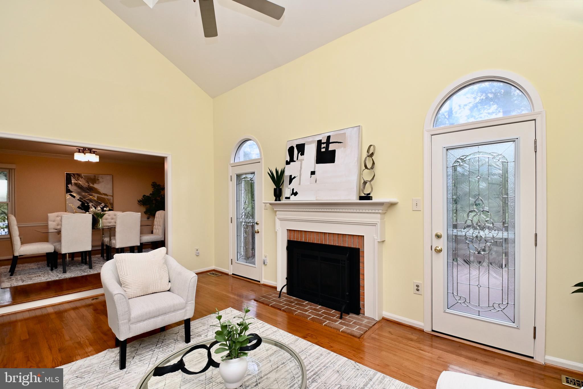 7443 Crestberry Lane Bethesda, MD 20817 - Photo 8 of 46 a living room with furniture a window and a fireplace