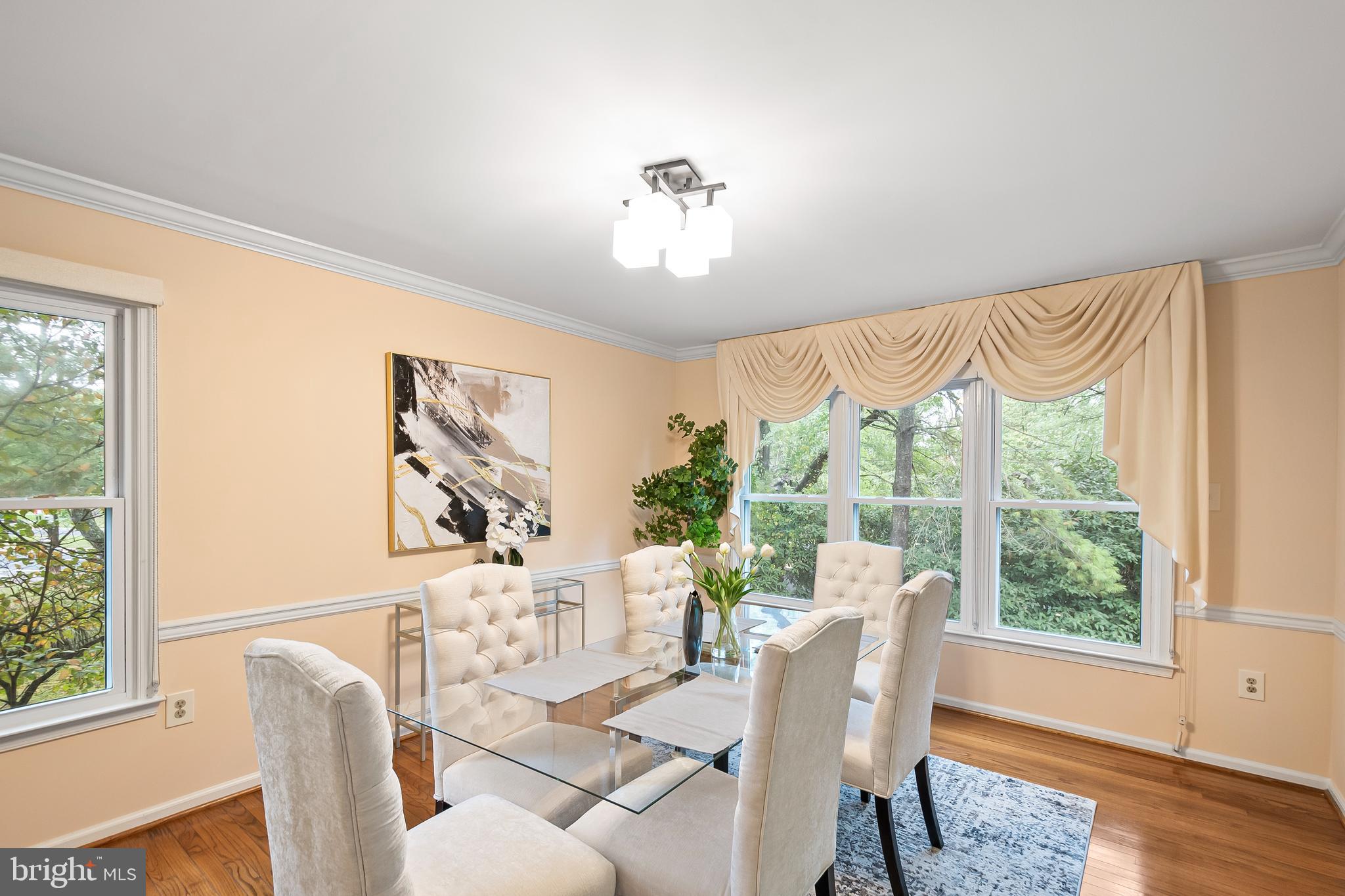 7443 Crestberry Lane Bethesda, MD 20817 - Photo 10 of 46 a view of a dining room with furniture a chandelier and wooden floor