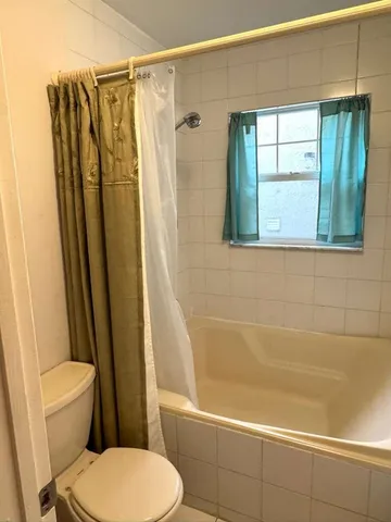 a bathroom with a glass door shower and a sink