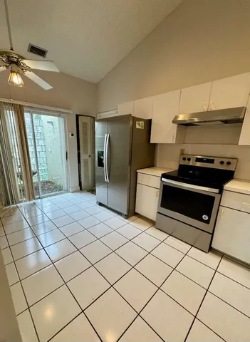 a kitchen with stainless steel appliances a stove a sink and a refrigerator