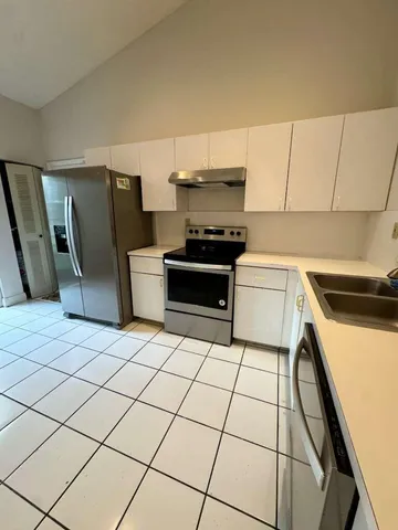a kitchen with a sink a stove and a refrigerator