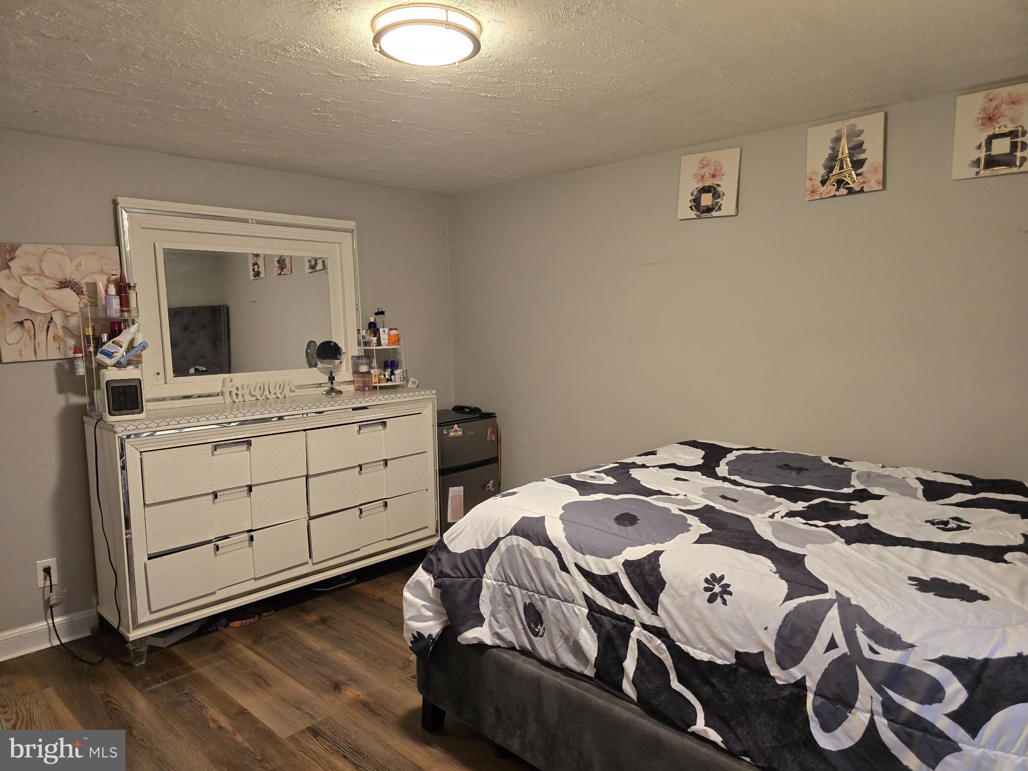 229 West 22nd Street Chester, PA 19013 - Photo 11 of 20 a bedroom with a bed and a dresser