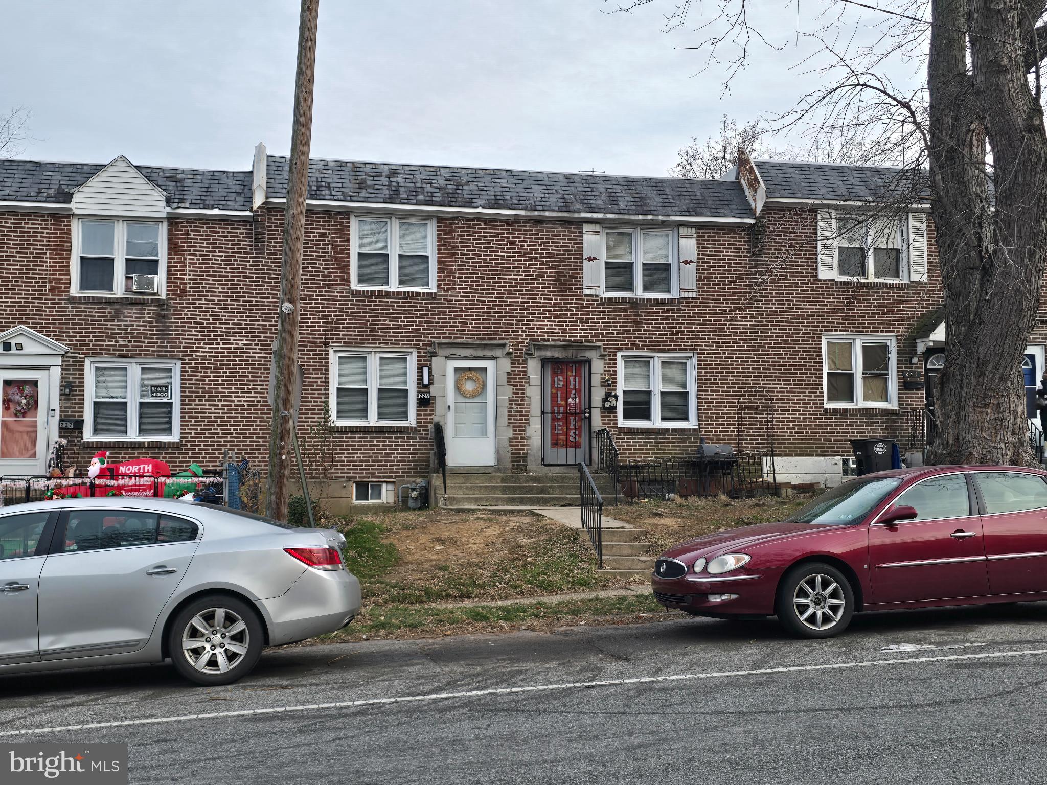 229 West 22nd Street Chester, PA 19013 - Photo 19 of 20 a front view of a house with parking space