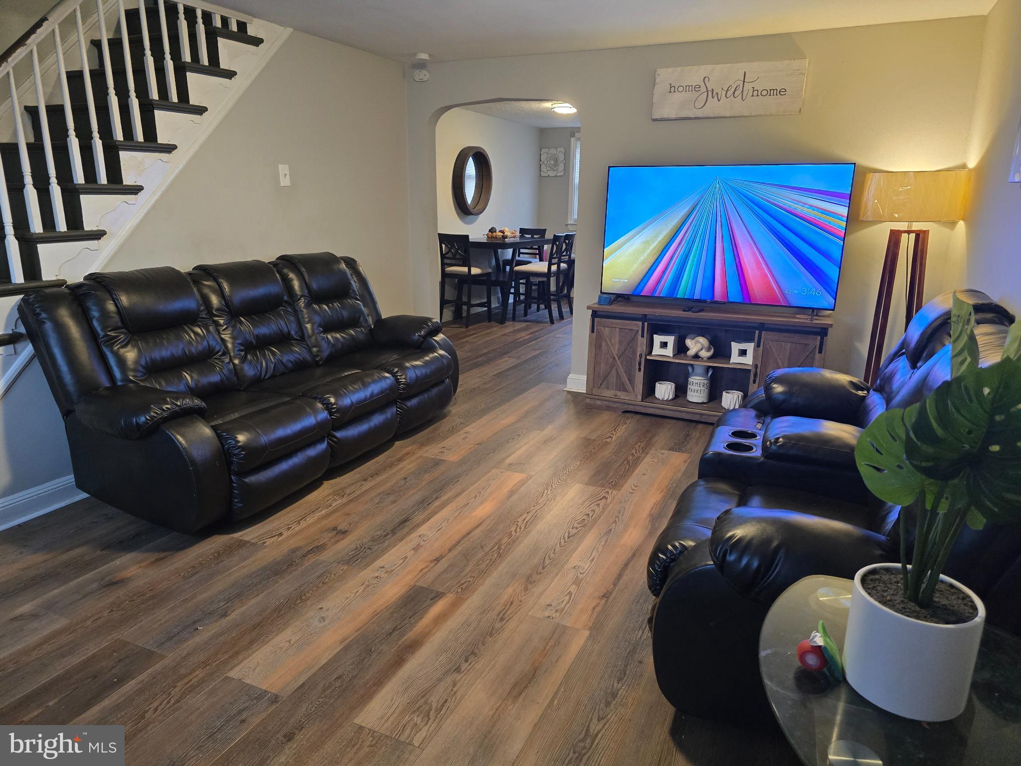 229 West 22nd Street Chester, PA 19013 - Photo 2 of 20 a living room with furniture a flat screen tv and a potted plant