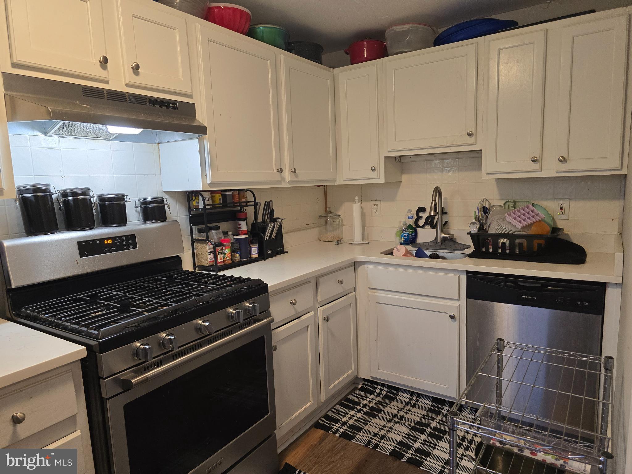 229 West 22nd Street Chester, PA 19013 - Photo 6 of 20 a kitchen with stainless steel appliances granite countertop a stove and white cabinets