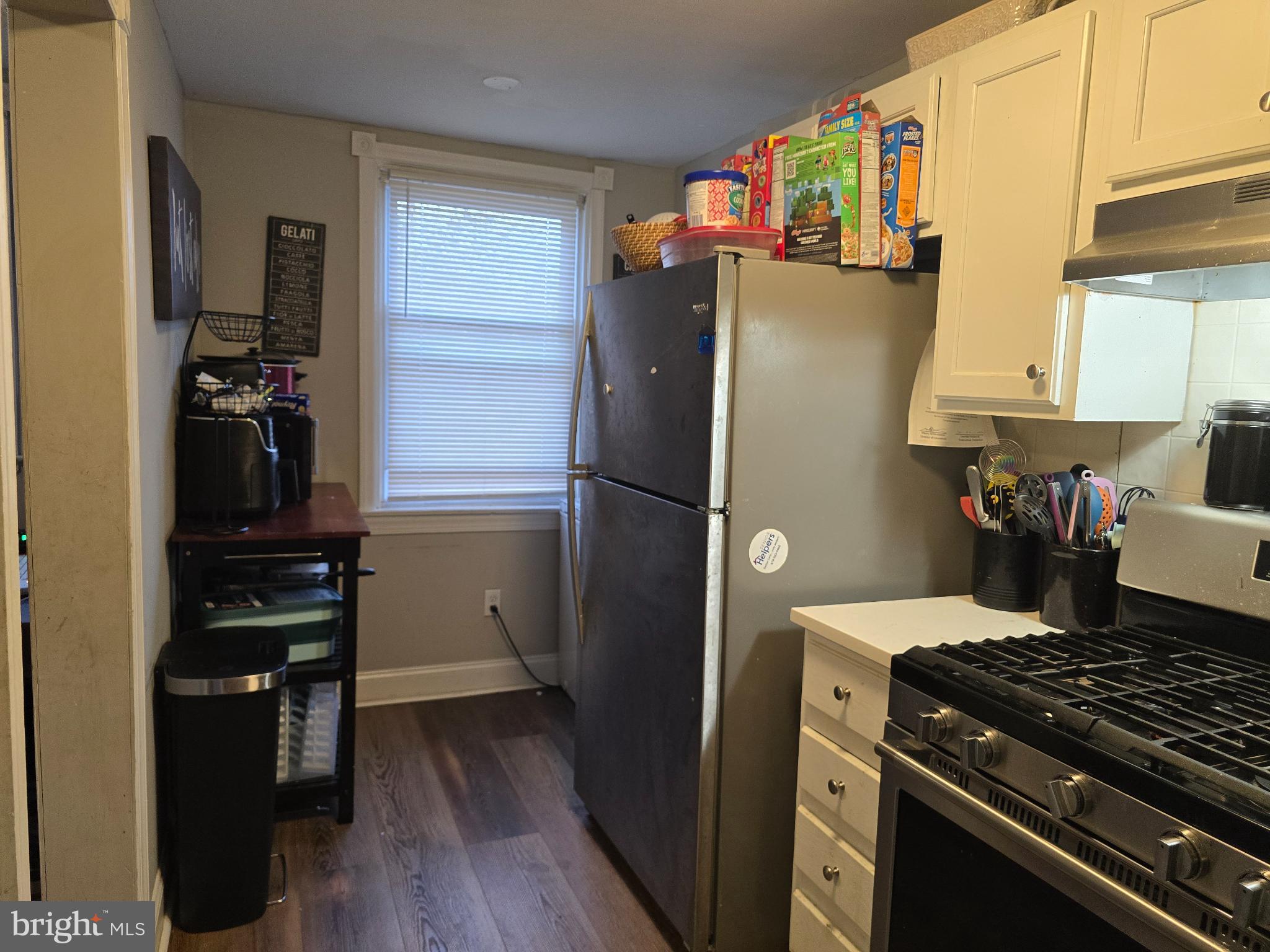 229 West 22nd Street Chester, PA 19013 - Photo 7 of 20 a kitchen with a refrigerator and a stove top oven