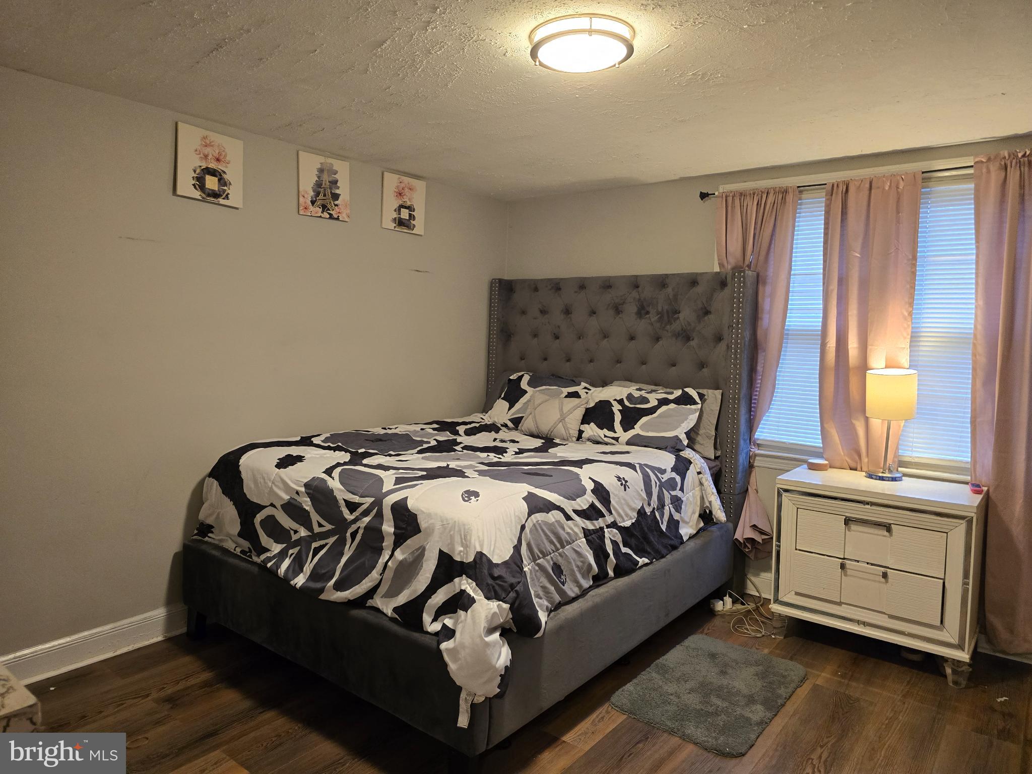 229 West 22nd Street Chester, PA 19013 - Photo 10 of 20 a bed sitting in a bedroom next to a window