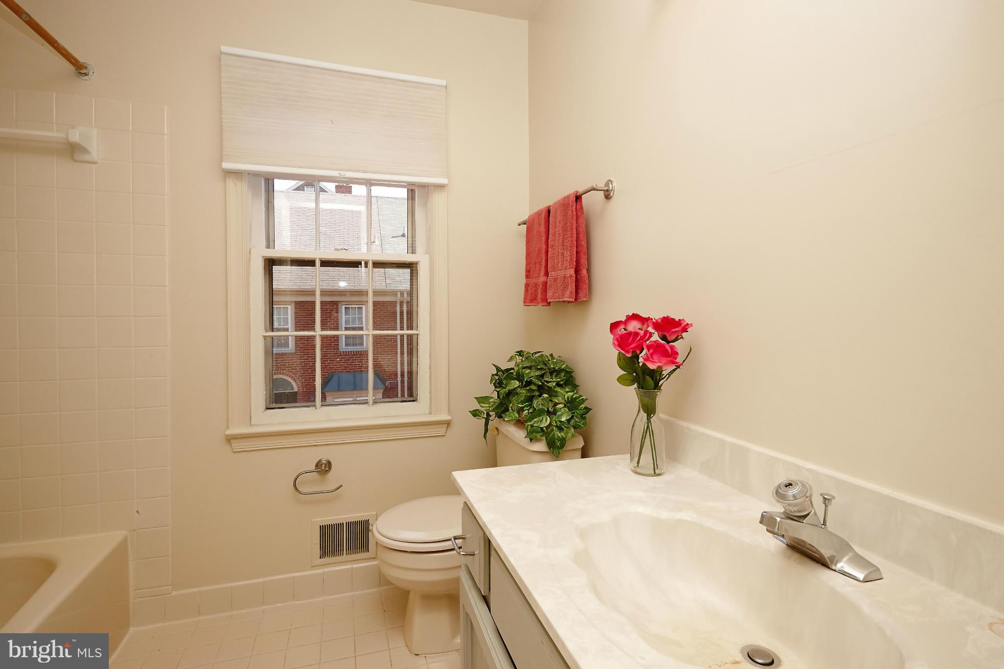 1235 Portner Road Alexandria, VA 22314 - Photo 15 of 25 a bathroom with a sink toilet and a mirror