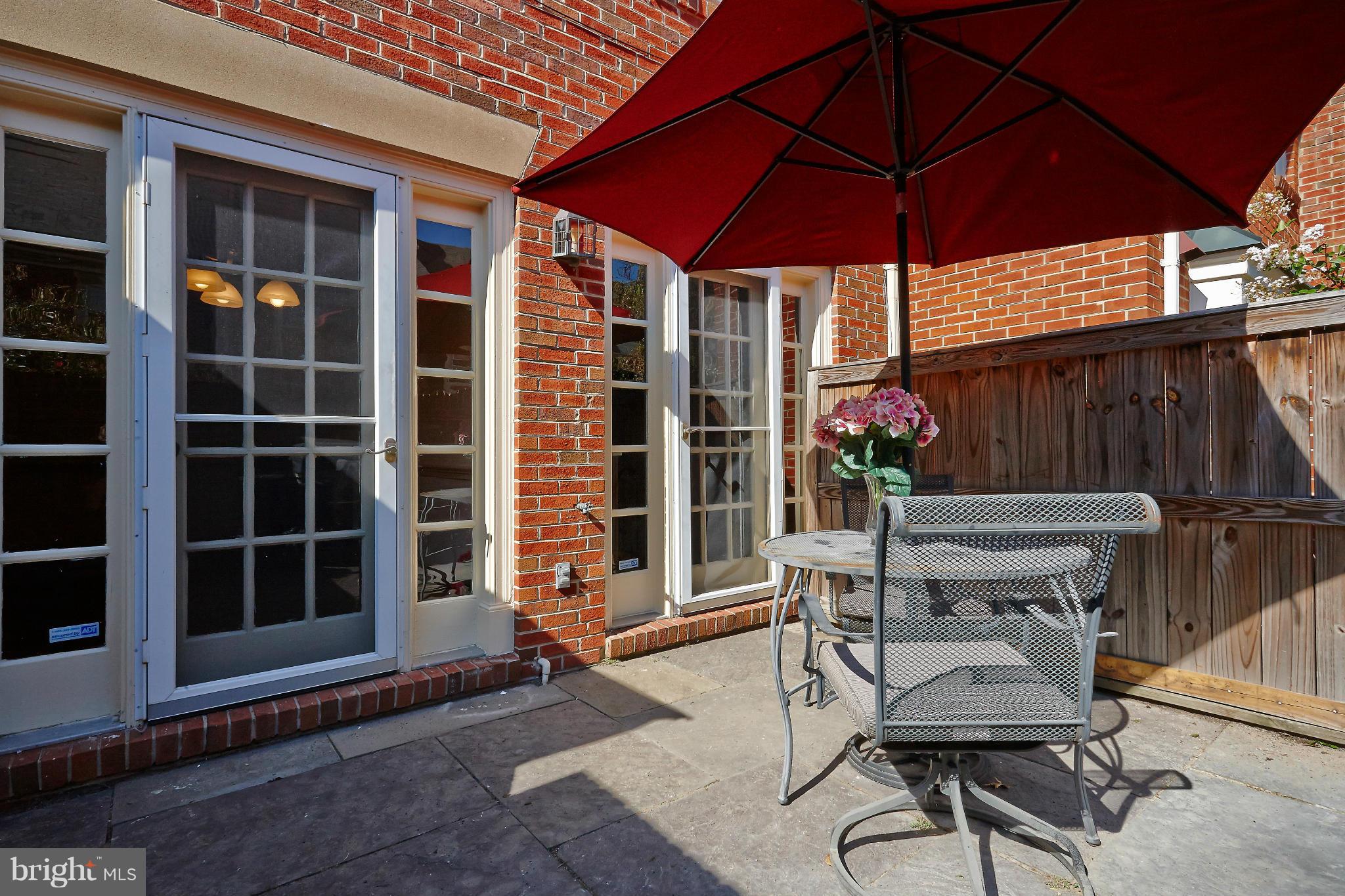 1235 Portner Road Alexandria, VA 22314 - Photo 18 of 25 a view of a chairs and table under an umbrella in front of house