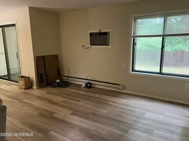a view of a room with wooden floor and a window