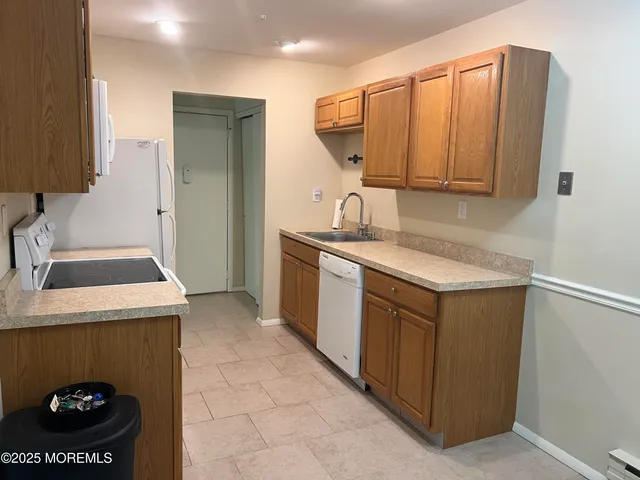 a kitchen with a sink and a refrigerator