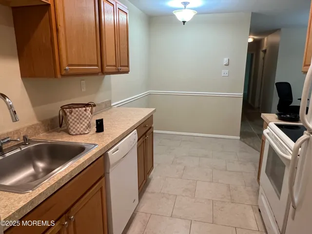 a kitchen with a sink and a stove top oven