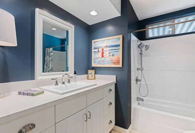 a bathroom with a double vanity sink a mirror and a shower