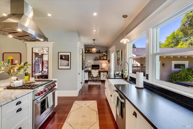 a kitchen with stainless steel appliances granite countertop counter space a stove and a large window
