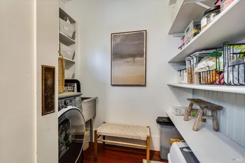 a view of room with guitars and wooden floor