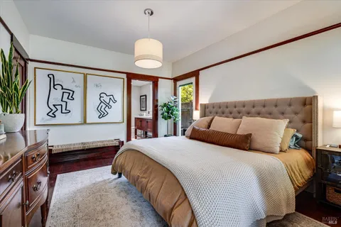 a bedroom with a bed and a large window