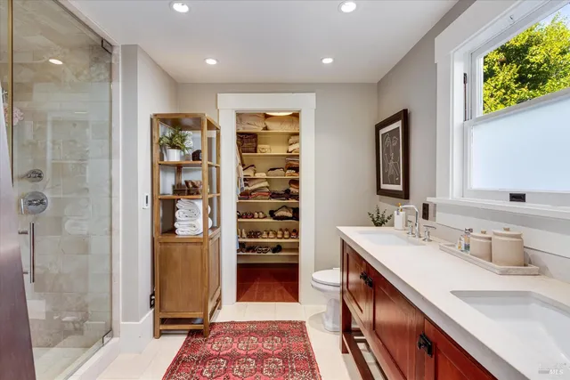a spacious bathroom with a double vanity sink and a mirror