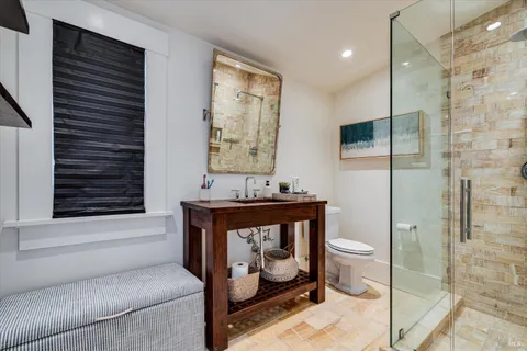 a bathroom with a toilet a sink and shower