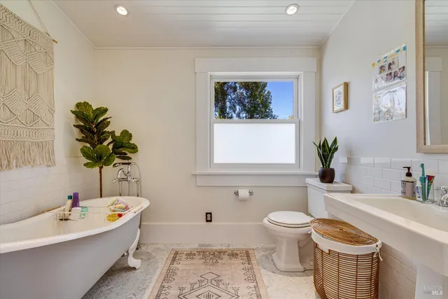 a bathroom with a toilet a sink and a bathtub