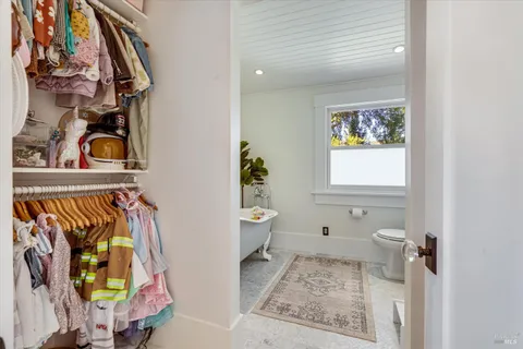 a bathroom with a toilet and a mirror