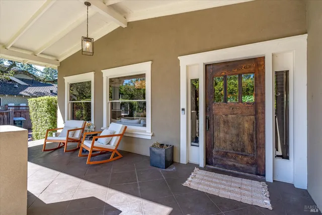 a building outdoor space with patio furniture and potted plants