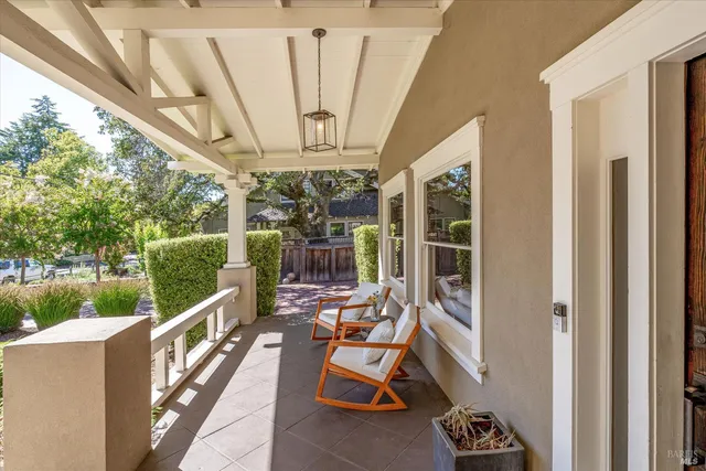 a view of a porch with furniture and a gate
