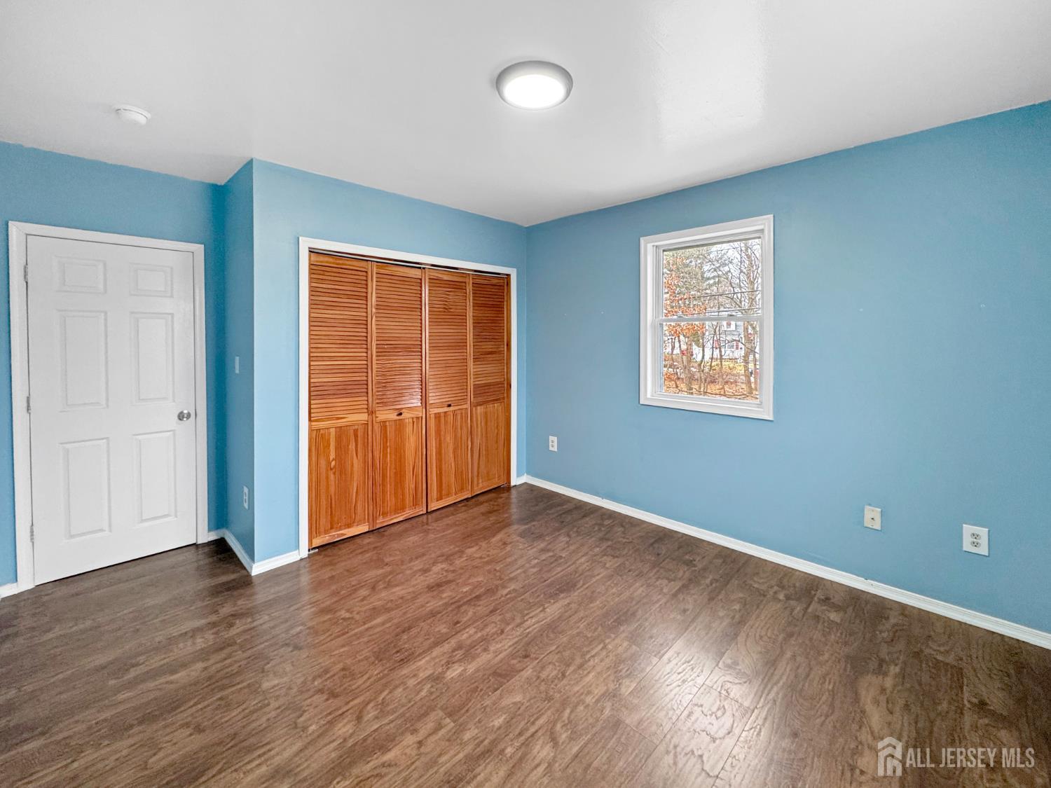 117 Old Post Road Edison, NJ 08817 - Photo 15 of 22 an empty room with wooden floor and windows