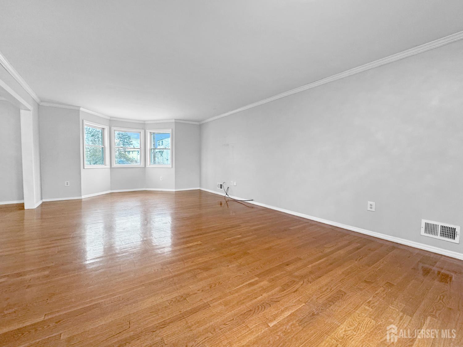 117 Old Post Road Edison, NJ 08817 - Photo 4 of 22 a view of empty room with wooden floor and fan