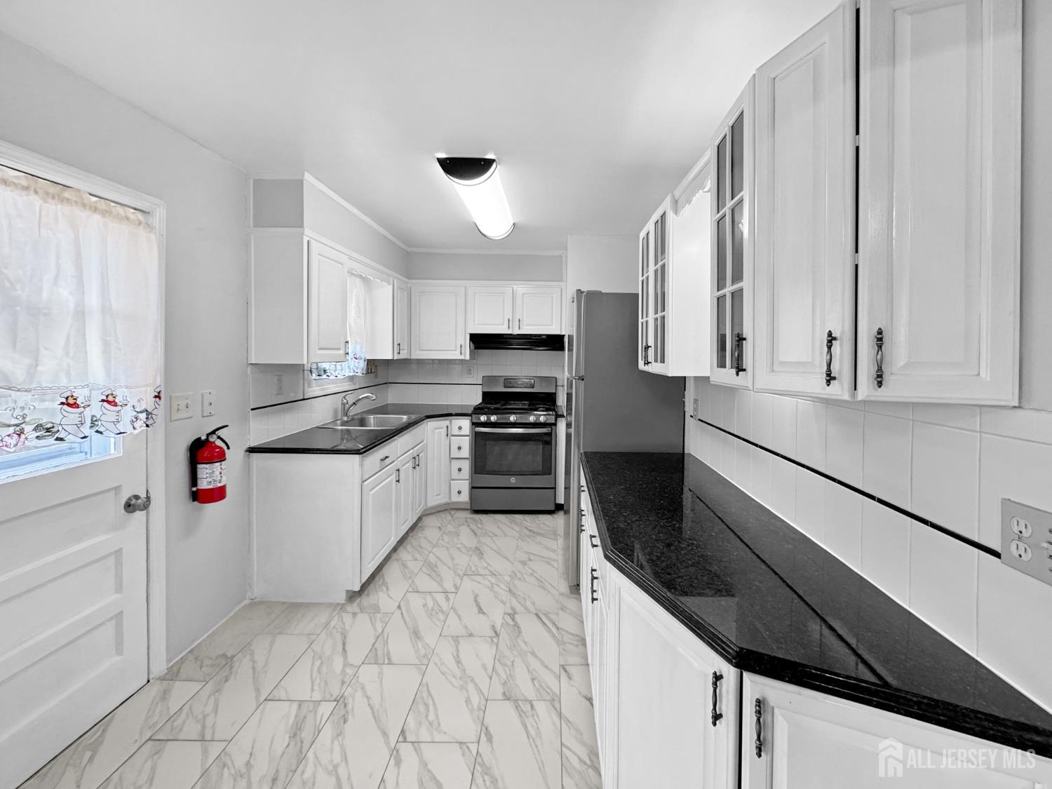 117 Old Post Road Edison, NJ 08817 - Photo 5 of 22 a kitchen with granite countertop white cabinets and white appliances